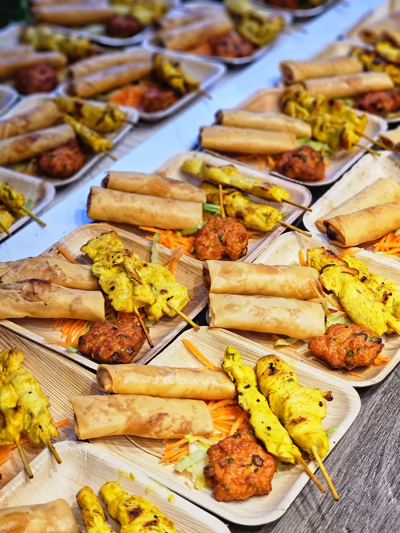 Trays of Thai canapés: mini spring rolls, chicken satay and fish cakes