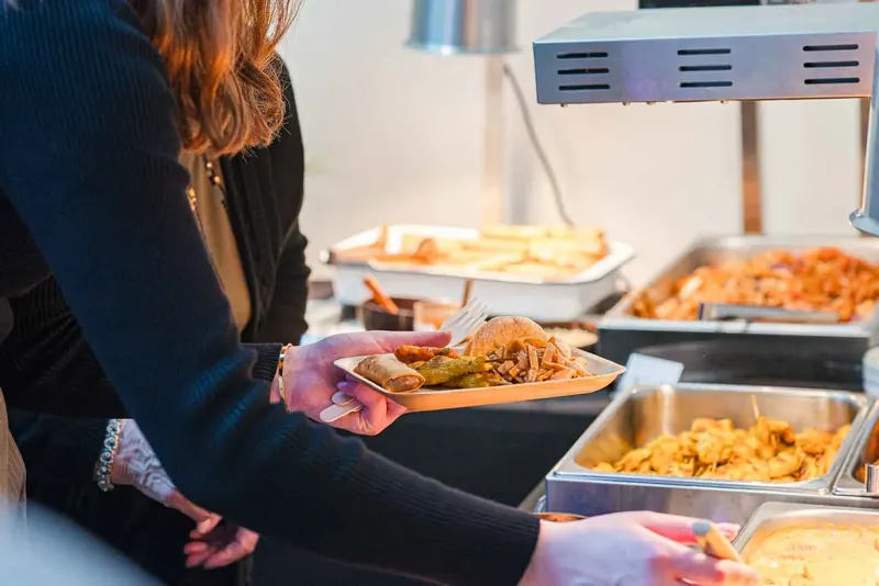 Guest served from a hot Thai buffet at a Christmas party