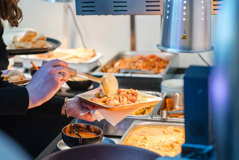 Pad thai being served at an event