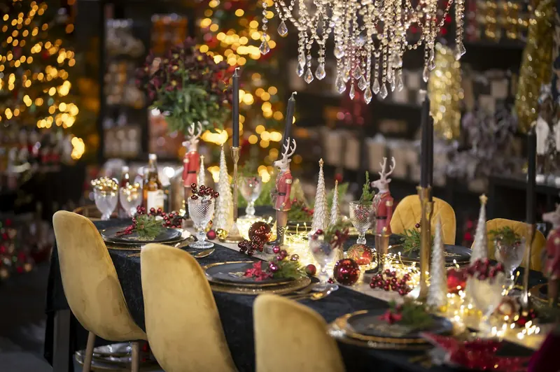 Festive party table with candles, fairy lights and Christmas decorations