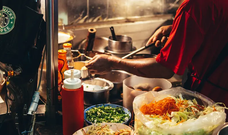Thai street food being cooked in a wok